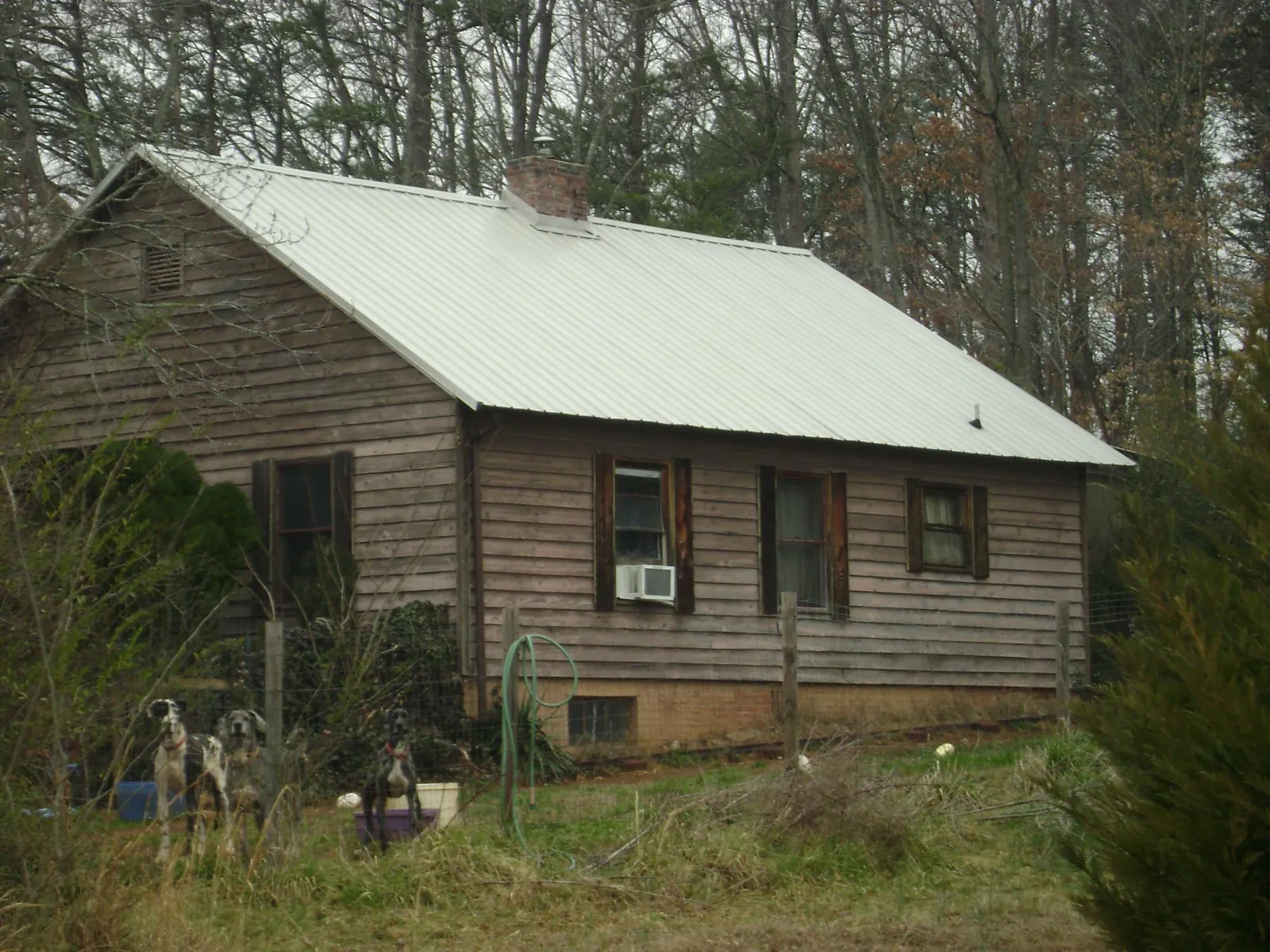 White metal roof on an old wood sided farmhouse, from a Metal Roof Installation job in Deweyville
